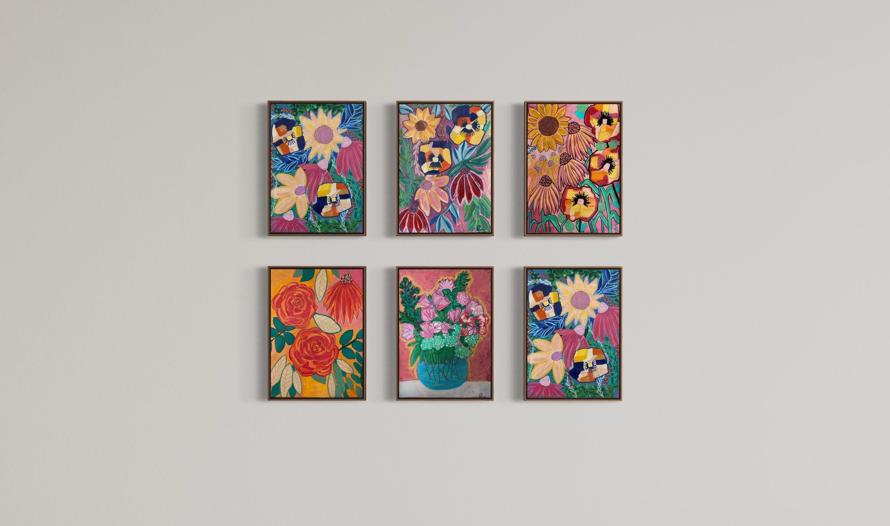 Six framed floral art prints arranged in two rows of three on a light gray gallery wall above a dark gray floor.